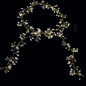 Macro shot of 1.5M handmade bridal hair vine with white pearls and crystals on gold wire