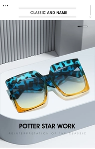 Macro detail of square tortoiseshell sunglasses with blue gradient lenses on a white platform