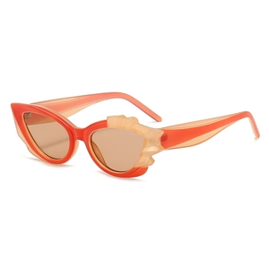 Cat eye flame sunglasses in orange and pink featuring translucent wavy frame design