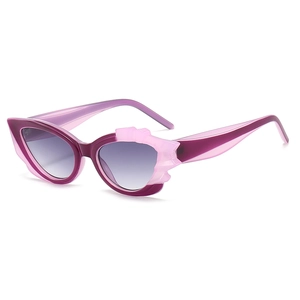 Fashionable purple cat eye sunglasses with decorative wings and gradient lenses for women