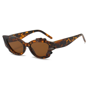 Tortoiseshell cat-eye sunglasses with geometric jagged frames and brown lenses