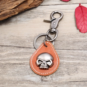 Vintage punk skull keychain in orange-brown leather with dark grey metal hardware