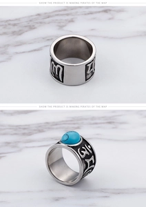 Close-up of vintage steel ring with blue stone and engraved mantra relief detail