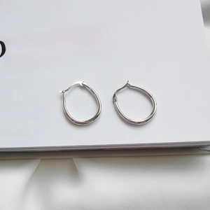 Macro shot of S925 sterling silver horseshoe buckle earring with 925 hallmark detail