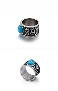 Detailed view of vintage titanium steel ring with turquoise stone and relief engraving