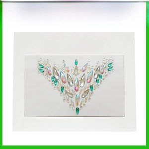 Detail of self-adhesive crystal body jewels featuring iridescent AB and green rhinestones