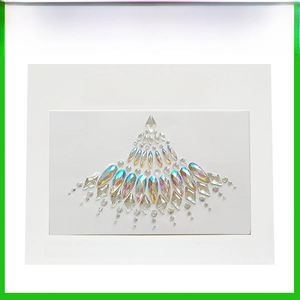 Macro shot of handcrafted AB crystal rhinestone chest and face jewels on adhesive backing