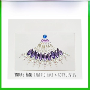 Detailed view of handmade crystal face and body jewels with blue and purple gemstones