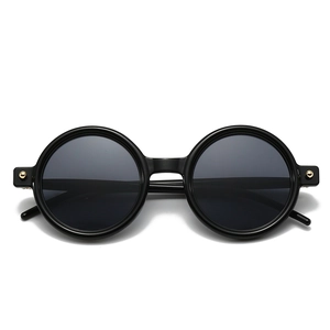 Vintage round frame sunglasses in black finish with golden metal rivet accents