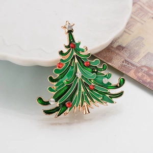 Detailed macro view of enamel Christmas tree brooch with colorful rhinestones