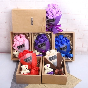 Detail of colorful scented soap rose gift boxes with cute teddy bear and craft paper bag