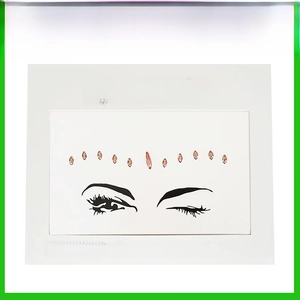 Close-up of pink marquise face jewels on transparent film for eye makeup styling
