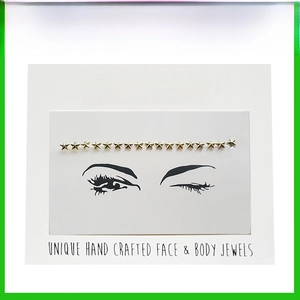 Detailed view of gold star crystal face jewels arranged on eye makeup display card