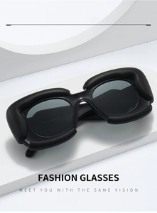 Detail of trendy thick black cloud-shaped frames and premium dark grey sunglasses lenses