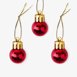 Detailed view of red Christmas ornaments with gold caps and strings for tree decoration