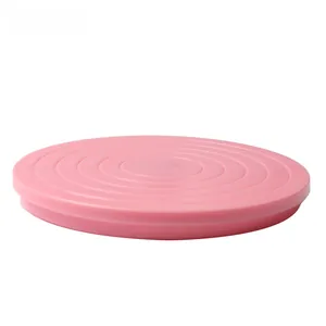 Top view of pink mini cake turntable with concentric circular scale and degree markings