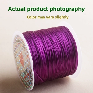 Macro view of purple stretchy beading cord wound on a spool for jewelry making