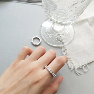 Minimalist S925 sterling silver zircon ring on model hand with elegant glass background