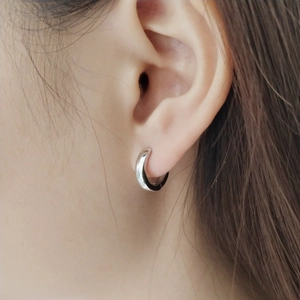 Polished 925 sterling silver hoop earrings shown on model for a minimalist jewelry look