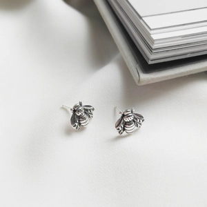 Minimalist 925 sterling silver bee stud earrings with antique silver finish on white background