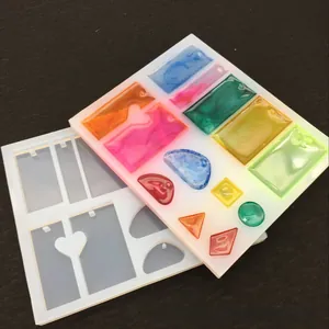 DIY silicone mold for resin crafts featuring teardrop, heart, and geometric shapes with holes