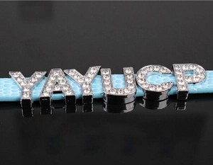 Detail of light blue leather strap with sparkling silver rhinestone sliding letters YAYUCP