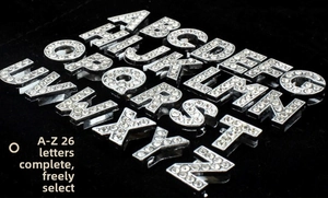 Macro shot of 26 sparkling white rhinestone silver metal letters A-Z for DIY jewelry