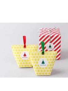 Close-up of festive Christmas gift boxes and bags with merry christmas stickers