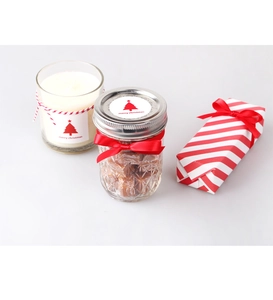 Christmas gift set with candle, candy jar and striped box decorated with festive stickers