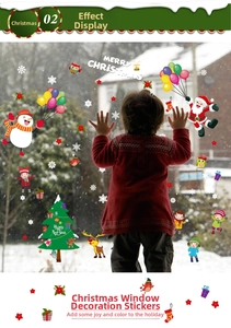 Detail of Christmas window stickers featuring Santa and reindeer on snowy glass