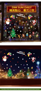Detail of Christmas window stickers featuring Santa, snowman and reindeer on glass