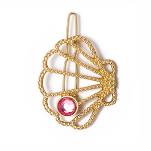 Golden shell hair clip with pink rhinestone and beaded metal texture on white background