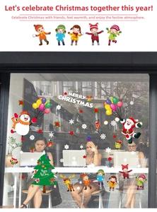 Detailed Christmas window decals featuring Santa, reindeer, and snowflakes on glass