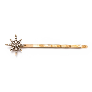 Macro detail of vintage gold star hair clip with brilliant white rhinestones inlay