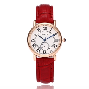 Detail of red leather strap women's quartz watch with rose gold case and Roman dial