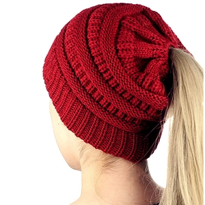 Red knit ponytail beanie for women with a functional opening shown on a model