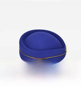 Detail of royal blue pillbox hat with golden trim and wings aviation insignia