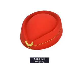 Detailed close-up of true red ceremonial wool hat with gold emblem and piping