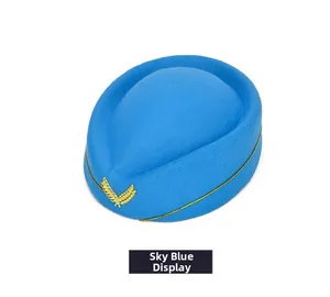 Close-up of sky blue wool stewardess pillbox hat with gold laurel badge and rope detail