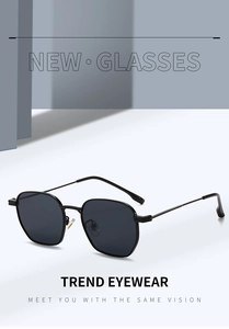 Detail view of stylish black hexagonal sunglasses with slim metal temples and dark lenses