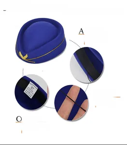 Detail of wool blend flight attendant hat showing embroidery, strap and size label