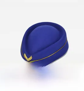Detailed embroidery of gold wheat ears on a navy blue pillbox flight attendant hat