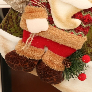 Linen Christmas stocking featuring Santa doll with red knit top and festive pine cone decor
