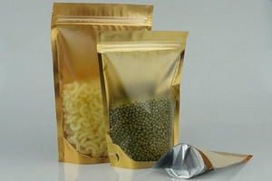 Detailed view of golden aluminum foil stand-up pouches with clear windows for food storage