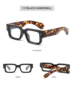Detail view of rectangular thick-rimmed glasses in black and tortoiseshell finish