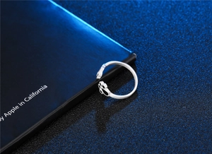 Close-up of cute cat paw open ring with brushed silver finish and black padding details