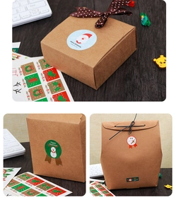 Detail of kraft paper Christmas gift boxes with festive stickers and decorative ribbons