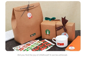 Close-up of Christmas stickers on gift bags and mugs with festive reindeer and Santa designs