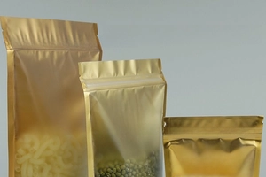 Detail of golden stand-up pouch with frosted window showing grains and secure zipper seal