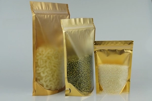 Three sizes of gold stand-up pouches with clear windows and resealable zippers for food